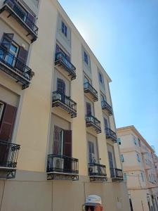 a man standing in front of a tall building at Studio64 in Civitavecchia