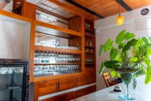 a bar with a wooden cabinet with wine glasses at Horizonte del Mar Hotel Boutique in Santa Marta