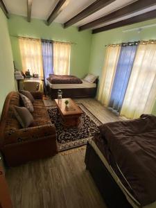 a living room with a couch and a table at The Norbu Retreat Hull in Kaza