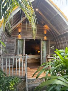 a wooden house with a bed in the middle at Jordan Guest House in Uluwatu