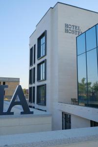 a hotel with a sign on the side of a building at Gaia in Türkistan