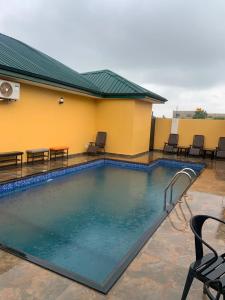 a swimming pool in front of a building at Archelux Developments in Bawalishi
