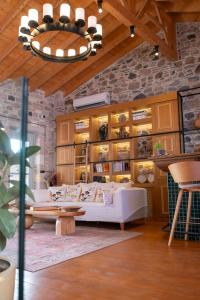 a living room with a couch and a chandelier at Qara Otel in Ayvalık