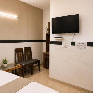 a hotel room with a flat screen tv on a wall at Hotel Goverdhan - Walking to Raja Ki Mandi Railway and 3km from ISBT in Agra
