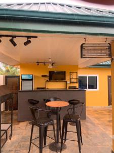 a patio with a table and chairs and a kitchen at Archelux Developments in Bawalishi