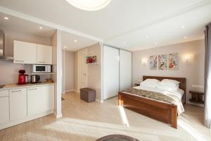 a bedroom with a bed and a kitchen at MyApartments in Tallinn