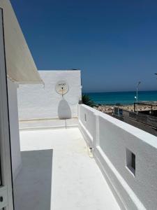 a view of the ocean from the balcony of a building at Dar El corniche in Mahdia +9 photos