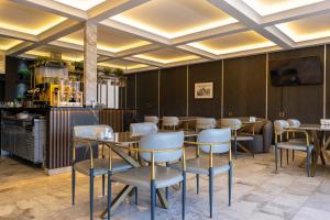 a restaurant with tables and chairs in a room at Elite World Homes Istanbul Bosphorus in Istanbul