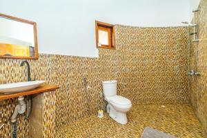 a bathroom with a toilet and a sink at Tanema Creek in Brufut +76 photos