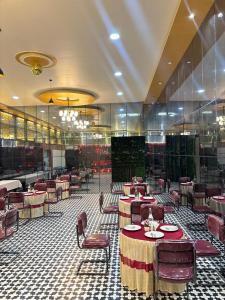 a restaurant with tables and chairs in a room at Anaya Regency in Naya Bāzār