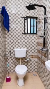 a bathroom with a toilet and a sink at Jeks Apartments Limited in Ogbunike +10 photos