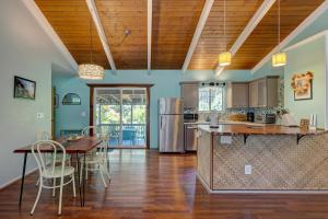 a kitchen and dining room with a table and chairs at Hale Ola Aina in Keaau