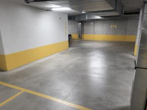 an empty parking garage with yellow and white walls at Urban Taft Stay Skopje-Modern Vodno View Suite with Private Parking in Taftalidze in Skopje