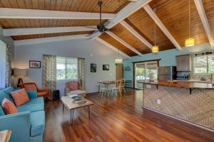 a living room with a blue couch and a table at Hale Ola Aina in Keaau