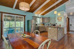 a kitchen and dining room with a wooden table and chairs at Hale Ola Aina in Keaau +23 photos