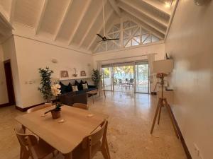 a living room with a table and a couch at Villa Arena Blanca in Punta Cana +5 photos
