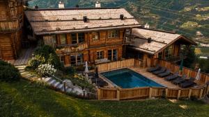 an overhead view of a house with a swimming pool at HochLeger - Chalet Refugium am Berg in Aschau