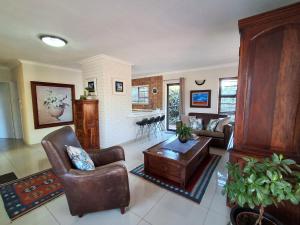 a living room with a couch and a table at Jasmine Guest Cottage in Benoni