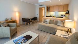 a living room with a bed and a kitchen at ABAV2 Suites by Rodos Palace in Ixia
