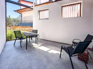 a patio with chairs and a table and a table and chairs at Andar's People in Sarajevo