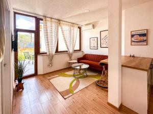 a living room with a red couch and a table at Andar's People in Sarajevo
