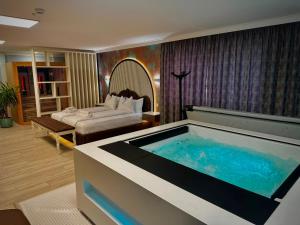 a hotel room with a large tub in a room at Hotel Zouk Suite Spa in Alba Iulia