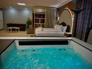 a hotel room with a tub with a bed at Hotel Zouk Suite Spa in Alba Iulia +96 photos
