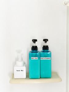 two blue bottles are sitting on a shelf at Lee Ryokan Tokyo in Tokyo