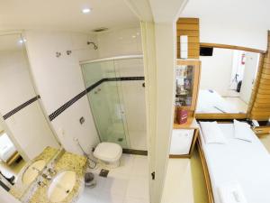 a bathroom with a shower and a sink and a toilet at Hotel Hostal (Adults Only) in Rio de Janeiro +70 photos