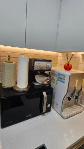 a microwave sitting on a kitchen counter next to a counter top at 대구 수성구 행복의집  +5 photos