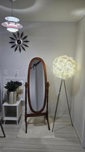 a dressing room with a mirror and a lamp at 대구 수성구 행복의집 