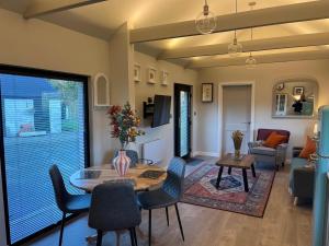 a living room with a table and chairs at Glassdrumman Stables in Ballynahinch