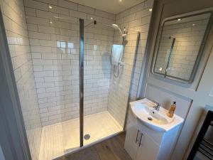a bathroom with a shower and a sink at Glassdrumman Stables in Ballynahinch +16 photos