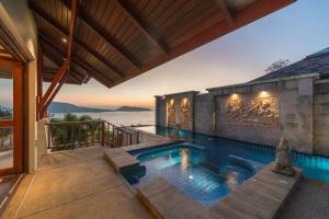 a swimming pool in a house with a view of the ocean at Patong 4BR Seaview Villa with Infinity Pool in Patong Beach