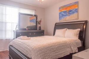 a bedroom with a bed with a large mirror at Port St Lucie Poolside Oasis in Port Saint Lucie +22 photos