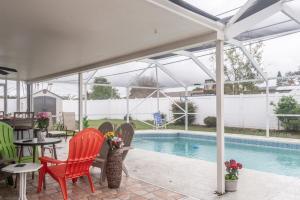 a patio with chairs and a swimming pool at Port St Lucie Poolside Oasis in Port Saint Lucie