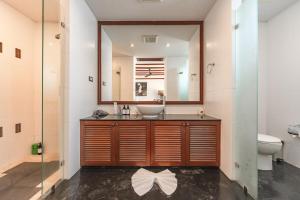 a bathroom with a sink and a mirror at Patong 4BR Seaview Villa with Infinity Pool in Patong Beach +35 photos