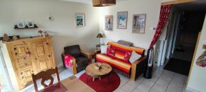 a living room with a couch and a table at Les Fermes du Lac - Appt 10A in Gérardmer