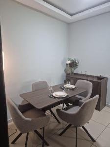 a dining room with a wooden table and chairs at Hcp appartement in Abidjan