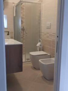 a bathroom with a toilet and a sink and a shower at B&B "Arberia"casa vacanze in San Giorgio Albanese +18 photos