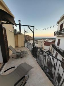 a balcony with chairs and a view of a city at B&B "Arberia"casa vacanze in San Giorgio Albanese