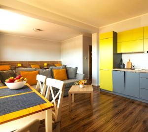 a kitchen and a living room with a couch and a table at Dom na Folwarku POKOJE I APARTAMENTY, BEZPŁATNY ZAMYKANY PARKING NA TERENIE POSESJI in Kielce