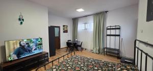 a living room with a large flat screen tv at Apartamente Dragasani in Drăgăşani
