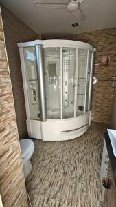 a small bathroom with a toilet in a room at Luxurious Duplex Villa in Hyderabad +37 photos