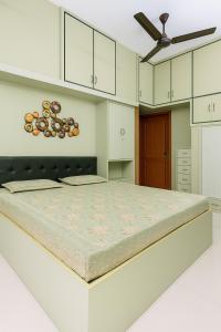 a large bed in a white room with white cabinets at Luxurious Duplex Villa in Hyderabad