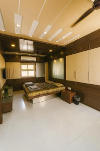 a large room with a bed and cabinets at Luxurious Duplex Villa in Hyderabad