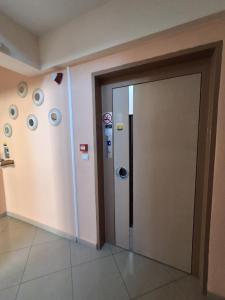 a room with a door and a wall with stickers at Olympic Studios Aslanidis in Olympic Beach