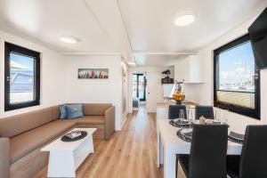 a living room with a couch and a table at Pearl Infinity Luxury Floating House in Novigrad Istria