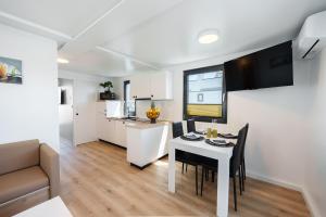 a kitchen and living room with a table and chairs at Pearl Infinity Luxury Floating House in Novigrad Istria +34 photos