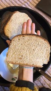a person holding a piece of bread on a plate at The Kalavan Retreat Center in Chambarak